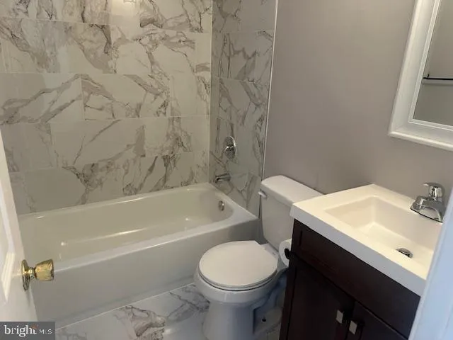 a bathroom with a sink toilet vanity and bathtub