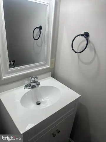 a white toilet sitting next to a shower