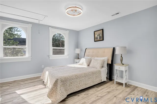 a bedroom with a bed and a window