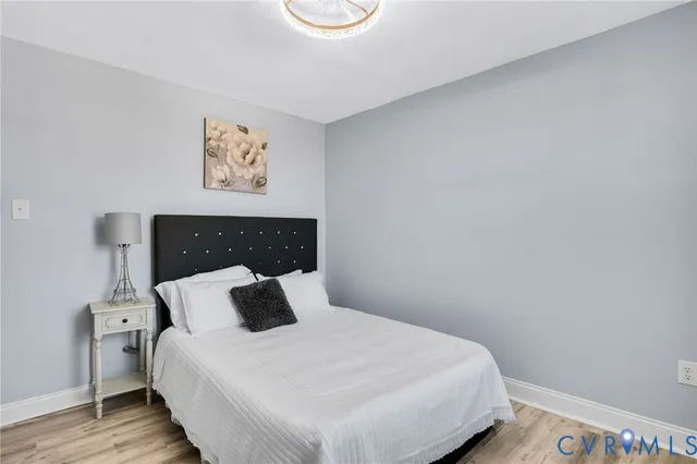 a bedroom with a bed and painting on the wall