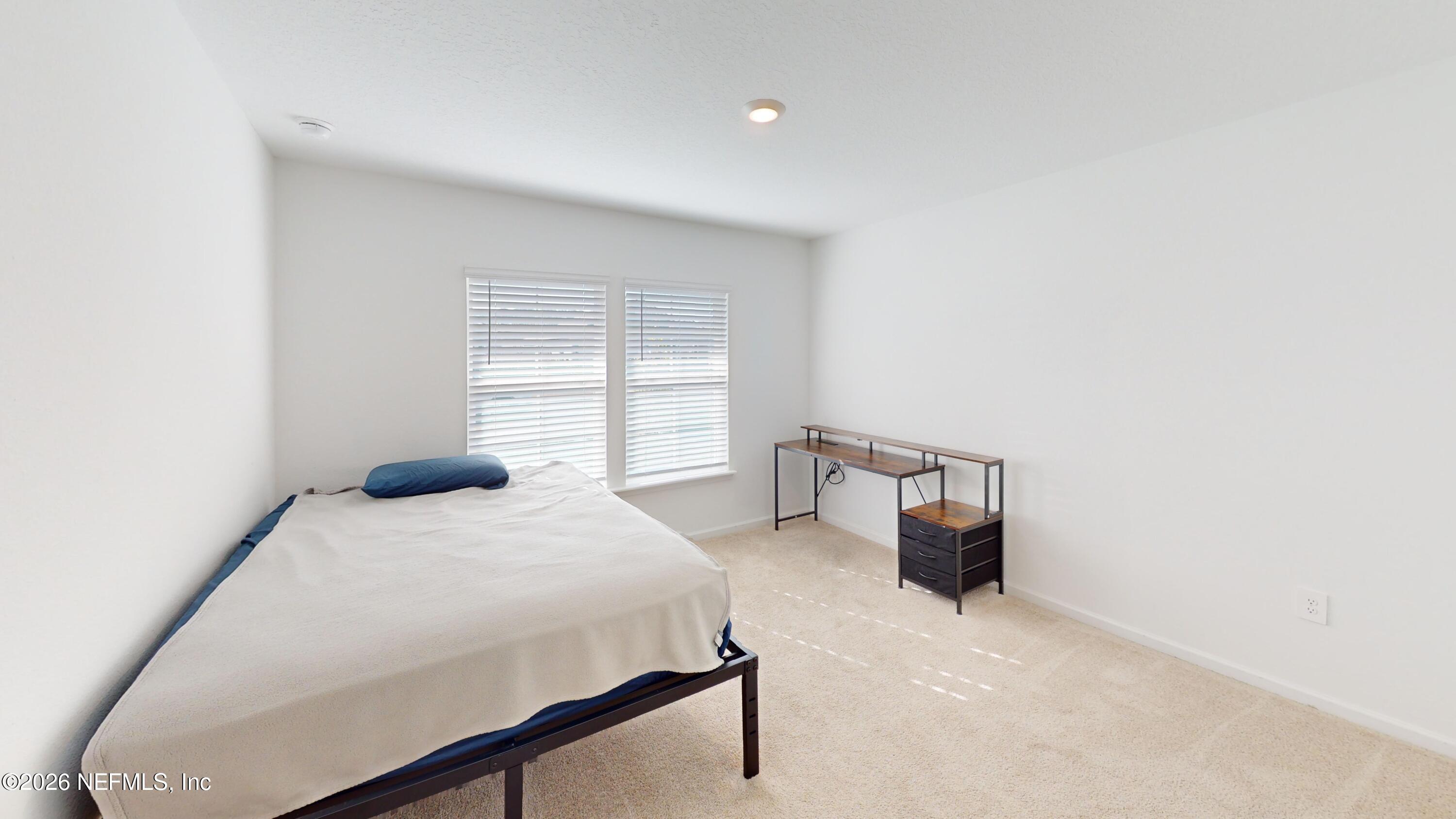 70625 Turtle Creek Yulee, FL 32097 - Photo 12 of 19 a bedroom with a bed and cabinets