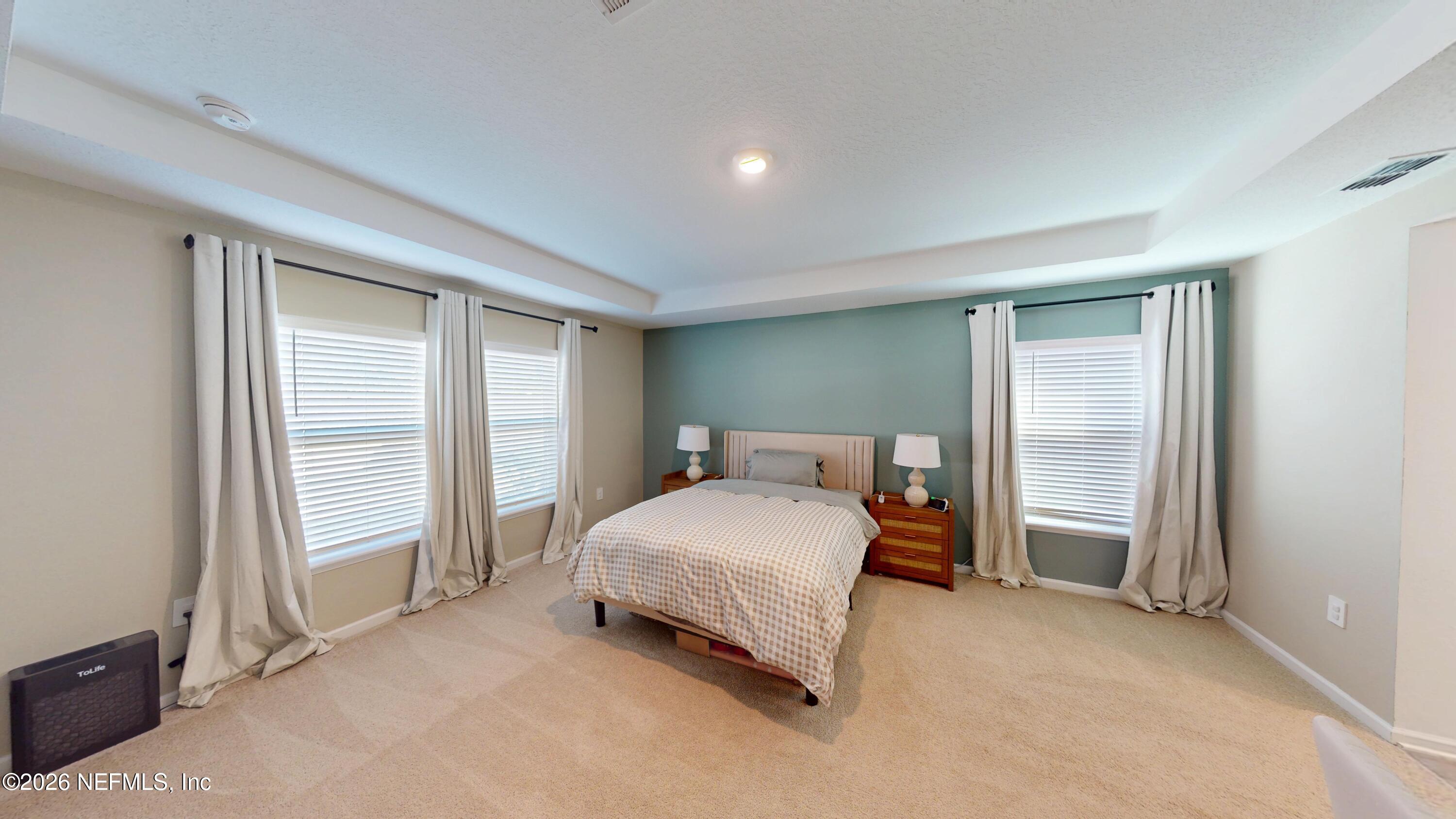 70625 Turtle Creek Yulee, FL 32097 - Photo 7 of 19 a bedroom with a bed and a window