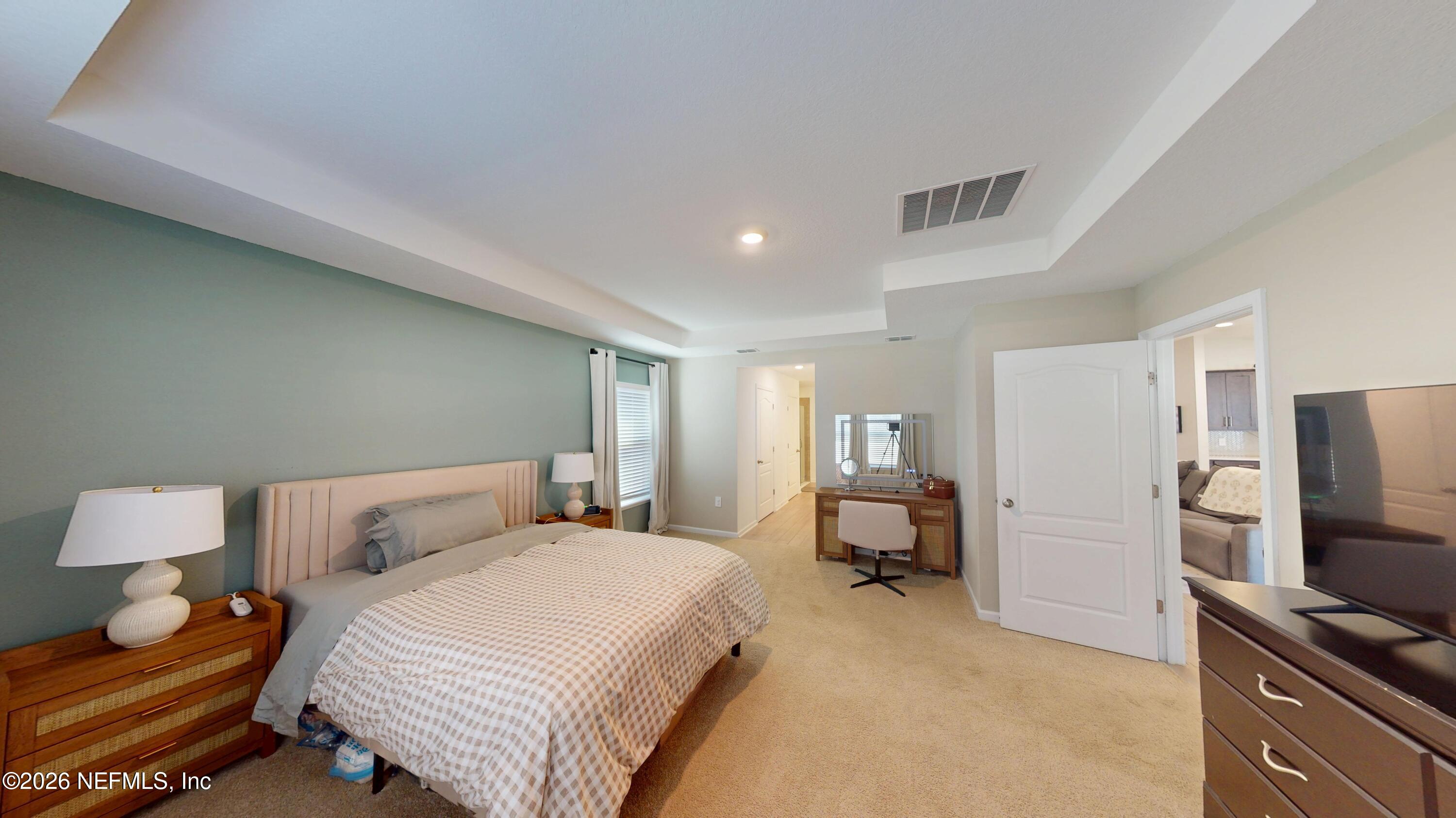 70625 Turtle Creek Yulee, FL 32097 - Photo 8 of 19 a bedroom with a bed and a flat screen tv