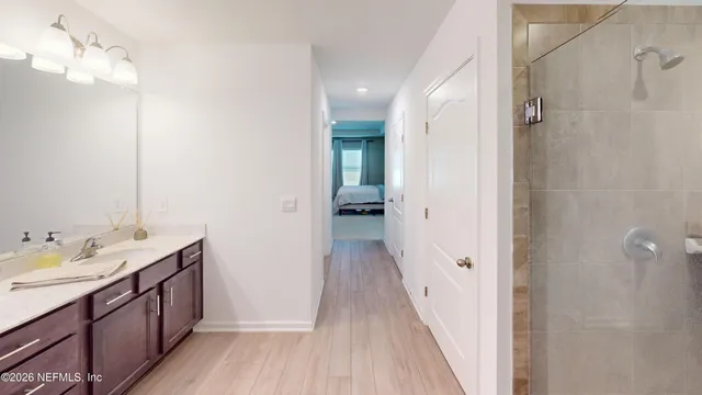 a bathroom with a double vanity sink and mirror