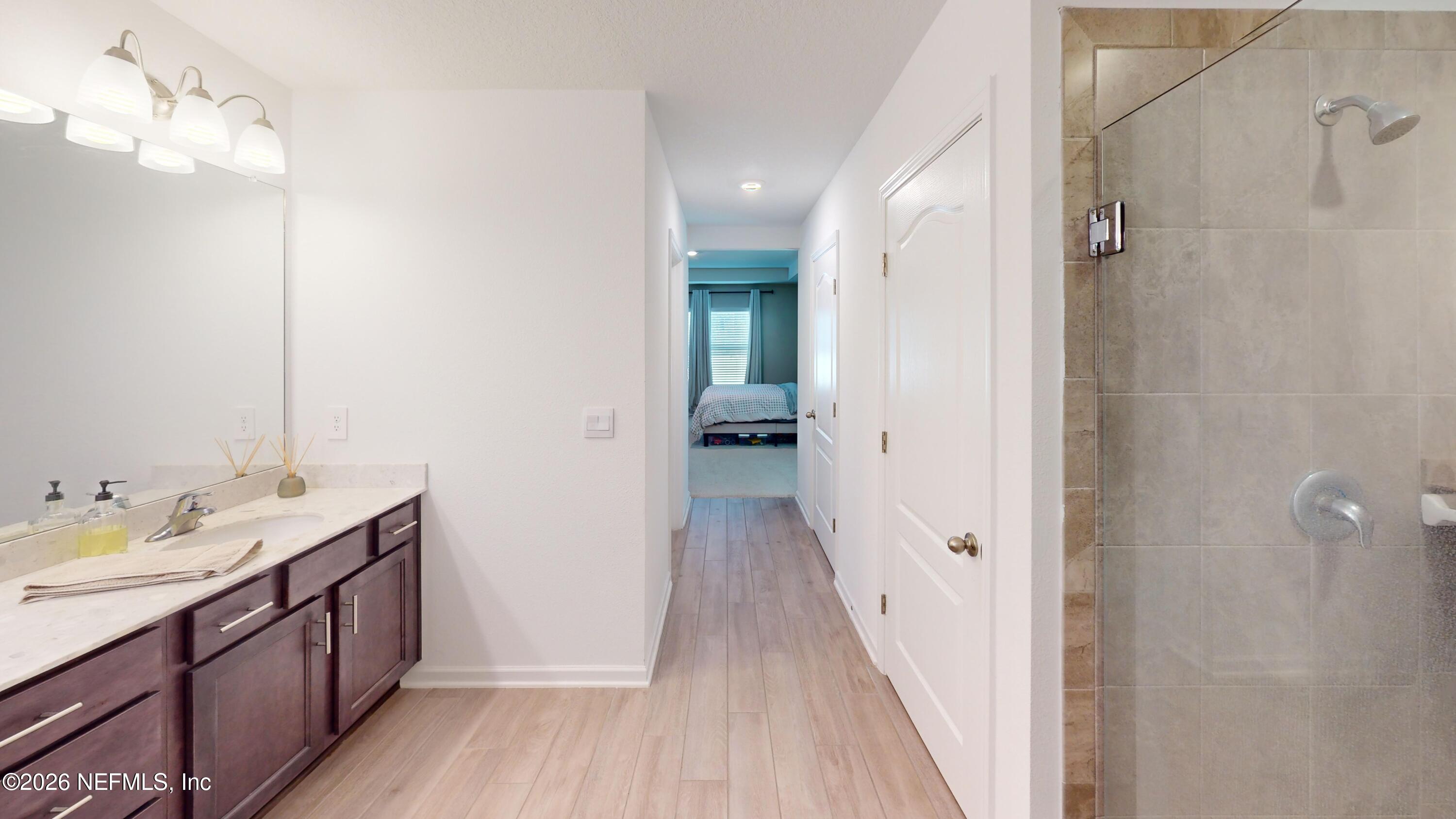 70625 Turtle Creek Yulee, FL 32097 - Photo 10 of 19 a bathroom with a double vanity sink and mirror