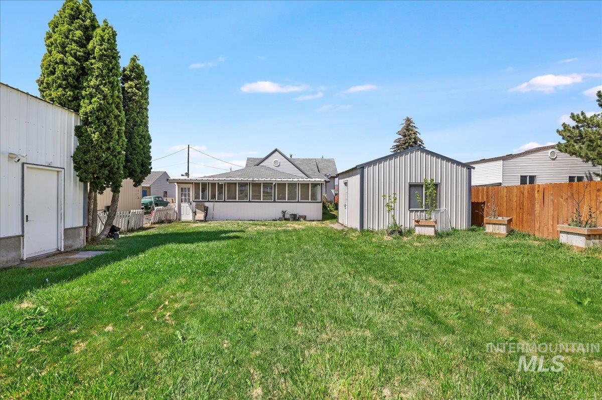 1017 Burley Avenue Buhl, ID 83316 - Photo 23 of 27 View of yard featuring a sunroom and an outbuilding