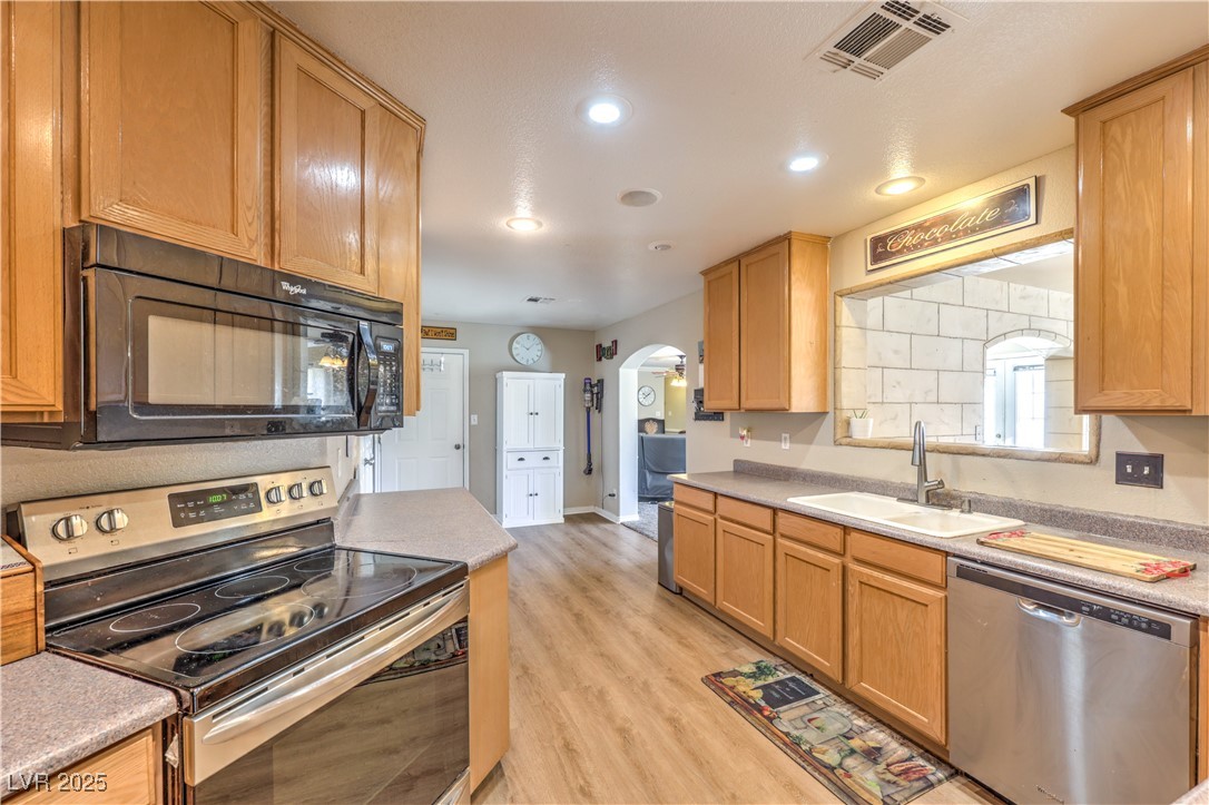 3192 North Taylor Street Logandale, NV 89021 - Photo 10 of 36 Kitchen with light wood-type flooring, appliances with stainless steel finishes, and sink