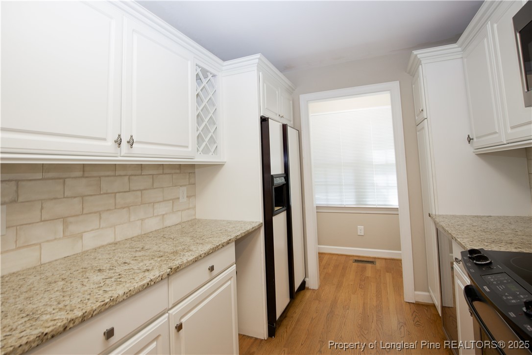 175 Knoll Road Southern Pines, NC 28387 - Photo 9 of 50 a kitchen with granite countertop a refrigerator and a sink