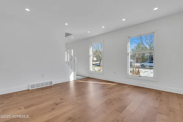 a view of an empty room with a fireplace and a window