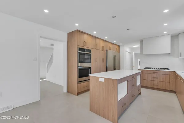 a room with a refrigerator and cabinets