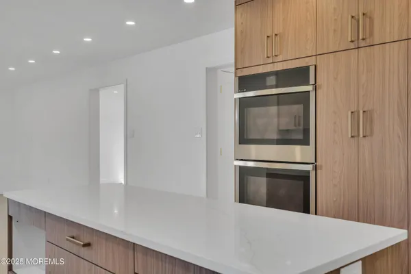 a kitchen with stainless steel appliances a refrigerator and a stove top oven
