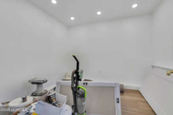 a view of a room with wooden floor and white walls