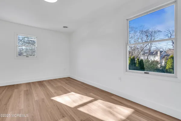 a view of a room with wooden floor