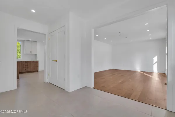 a view of an empty room and a bathroom