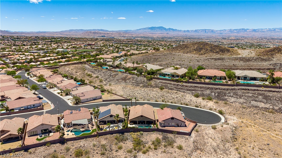 2256 Dogwood Ranch Avenue Henderson, NV 89052 - Photo 10 of 51 An aerial perspective reveals a vibrant neighborhood with inviting pools and commanding mountain panoramas.