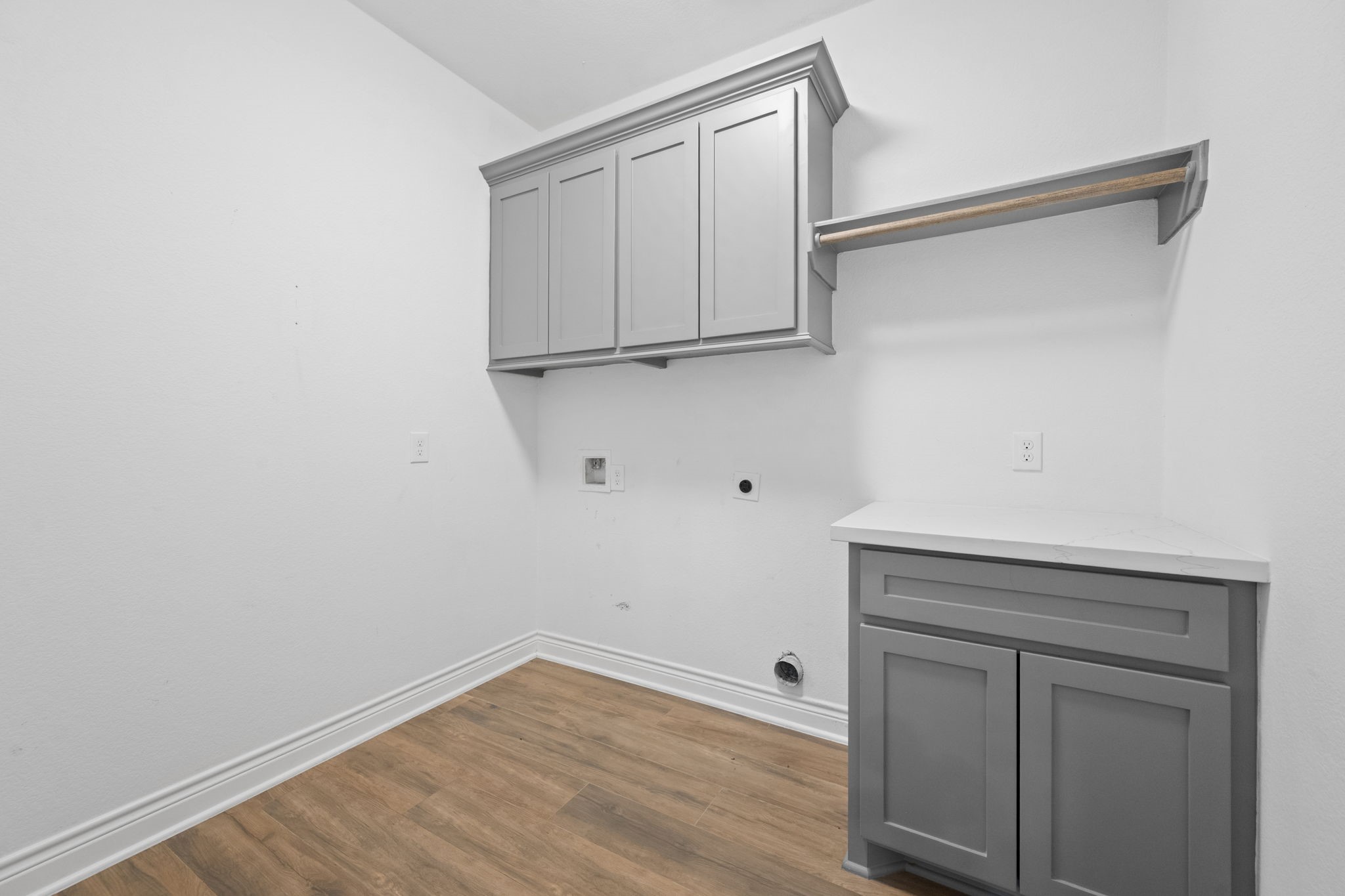 7815 Timber Switch Road Cleveland, TX 77328 - Photo 25 of 39 Spacious laundry room with sleek gray cabinetry, ample storage, and a convenient countertop for folding.