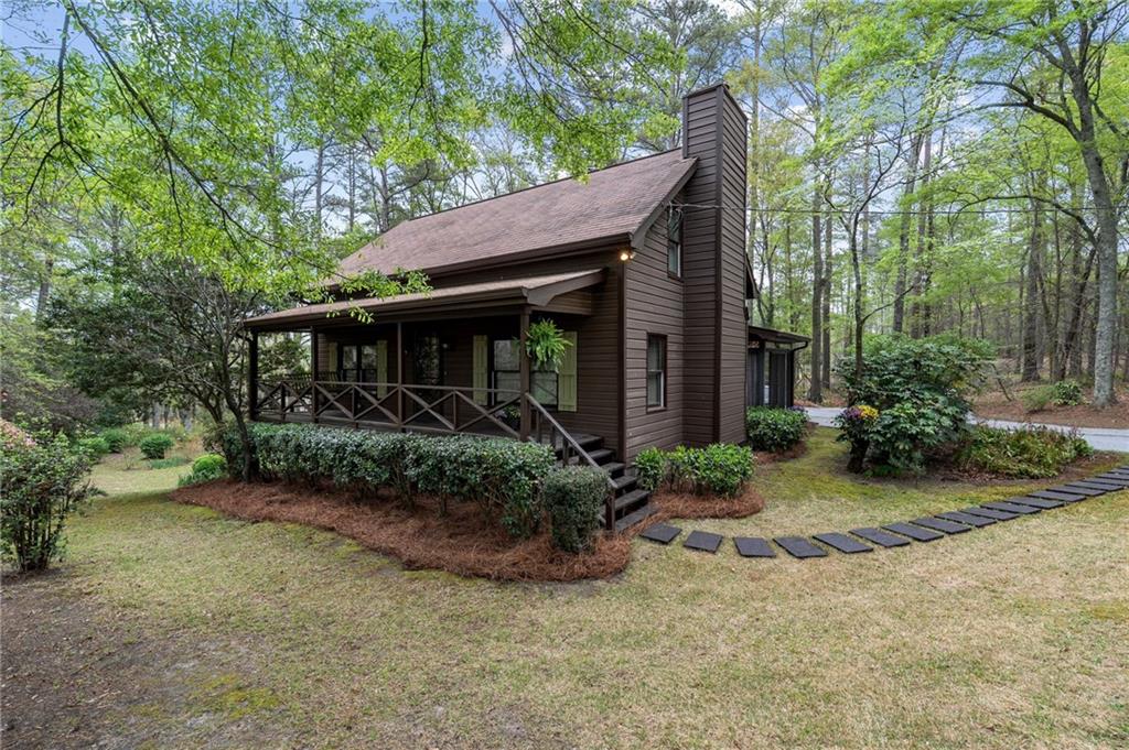 3121 Bonds Lake Road Northwest Conyers, GA 30012 - Photo 3 of 36 a front view of a house with garden
