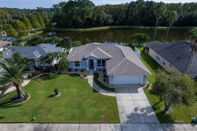 an aerial view of a house with swimming pool and garden