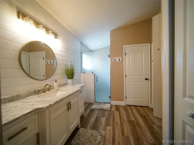 a spacious bedroom with a bed and a dresser