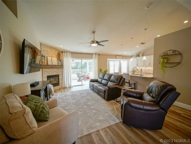 a living room with furniture fireplace and a flat screen tv