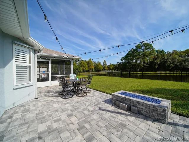 a view of backyard with a patio
