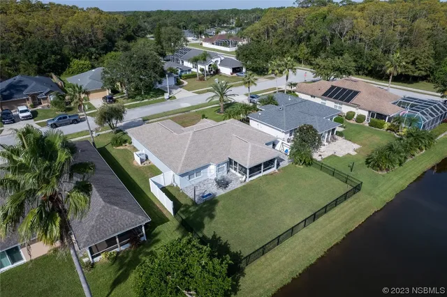 an aerial view of residential houses with outdoor space and street view