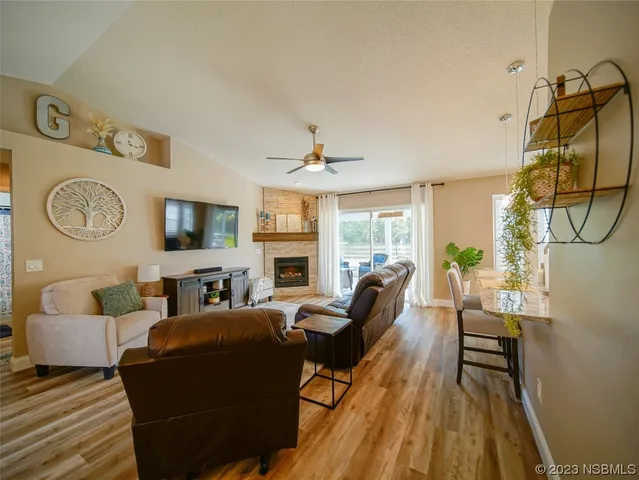 a living room with furniture a large window and a clock