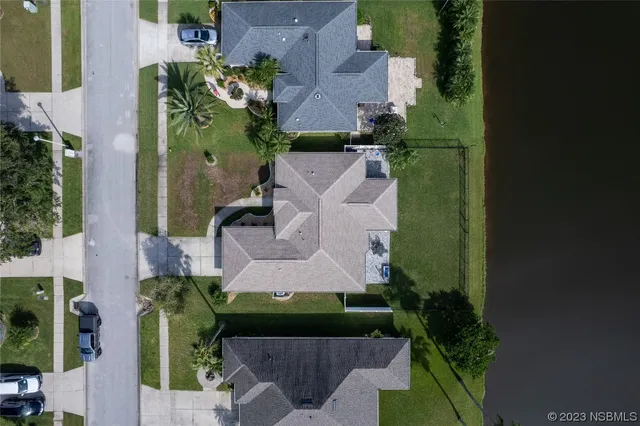 an aerial view of a house with a yard