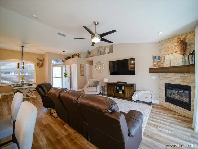 a living room with furniture a fireplace and a flat screen tv