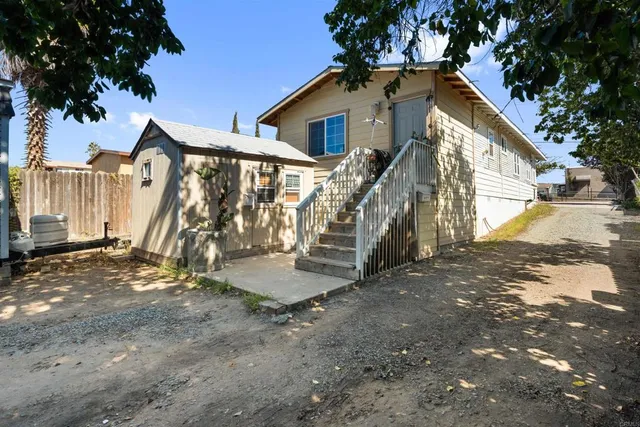 a kitchen area with furniture and appliances