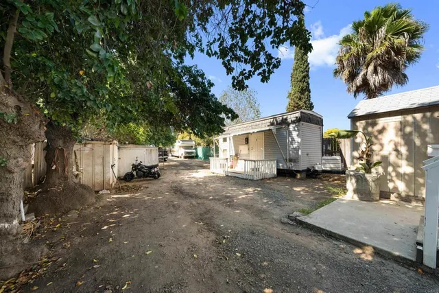 an aerial view of residential houses with outdoor space and trees