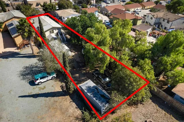 an aerial view of residential houses with outdoor space