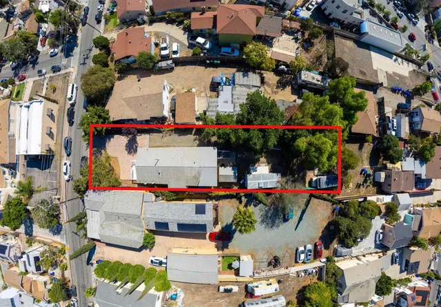 an aerial view of a house with a yard
