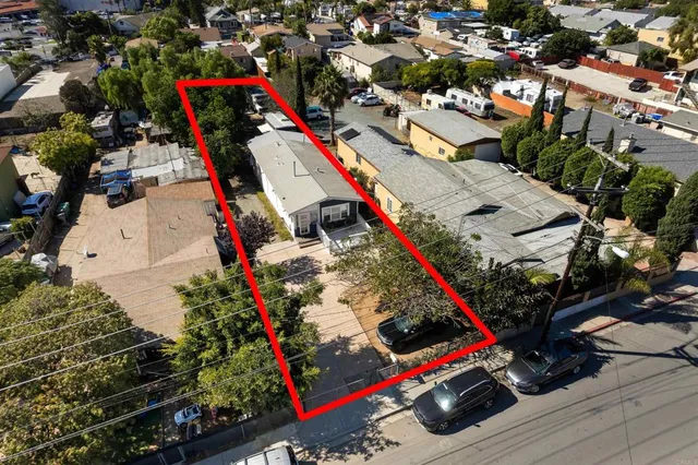 an aerial view of a house with a yard basket ball court and outdoor seating