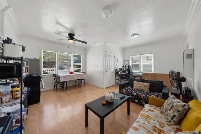 a living room with furniture a window and gym equipment