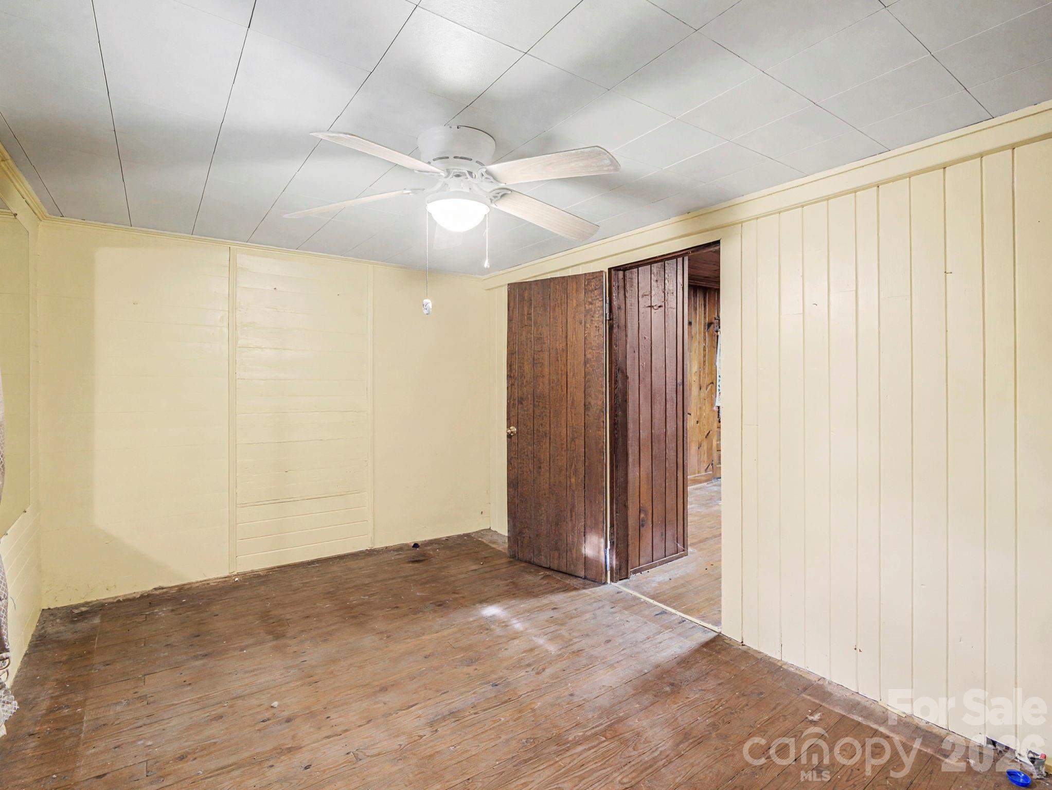 1526 Bills Creek Road Lake Lure, NC 28746 - Photo 16 of 25 an empty room with a ceiling fan and a window