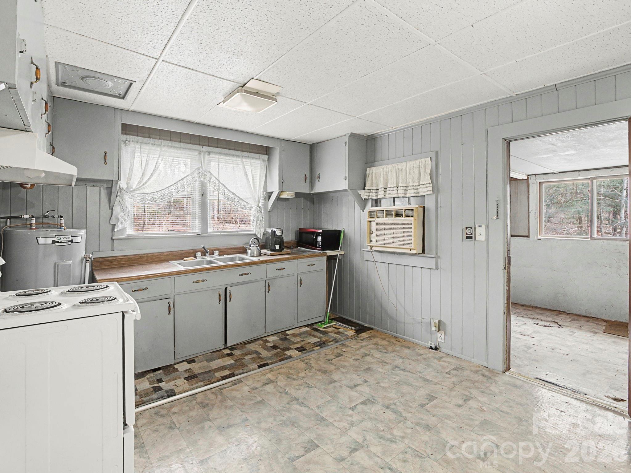 1526 Bills Creek Road Lake Lure, NC 28746 - Photo 17 of 25 a kitchen with a stove a sink dishwasher and a refrigerator