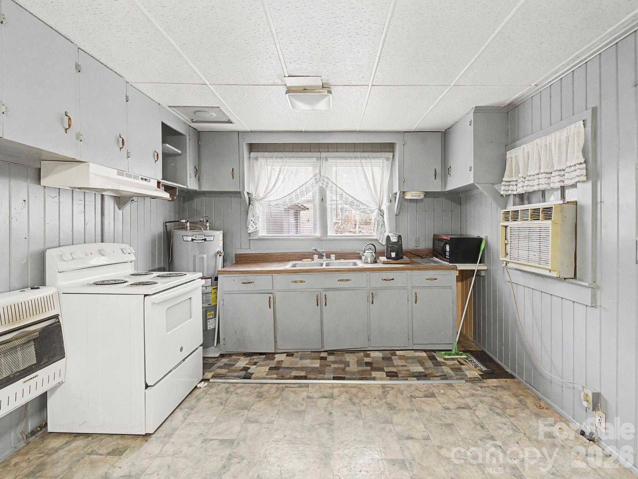 1526 Bills Creek Road Lake Lure, NC 28746 - Photo 18 of 25 a kitchen with a stove a sink and a refrigerator