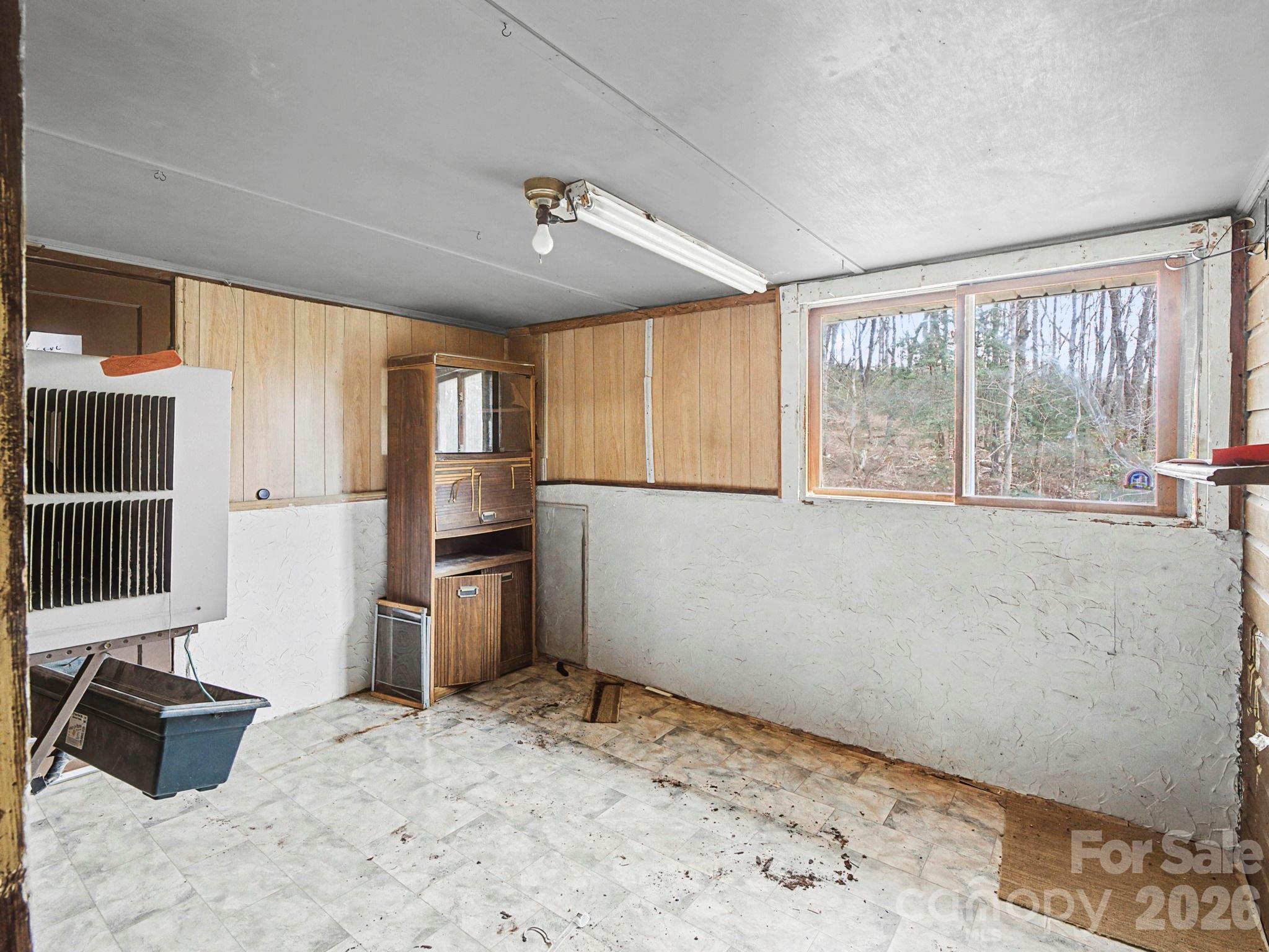 1526 Bills Creek Road Lake Lure, NC 28746 - Photo 20 of 25 a room with a bed and a large window