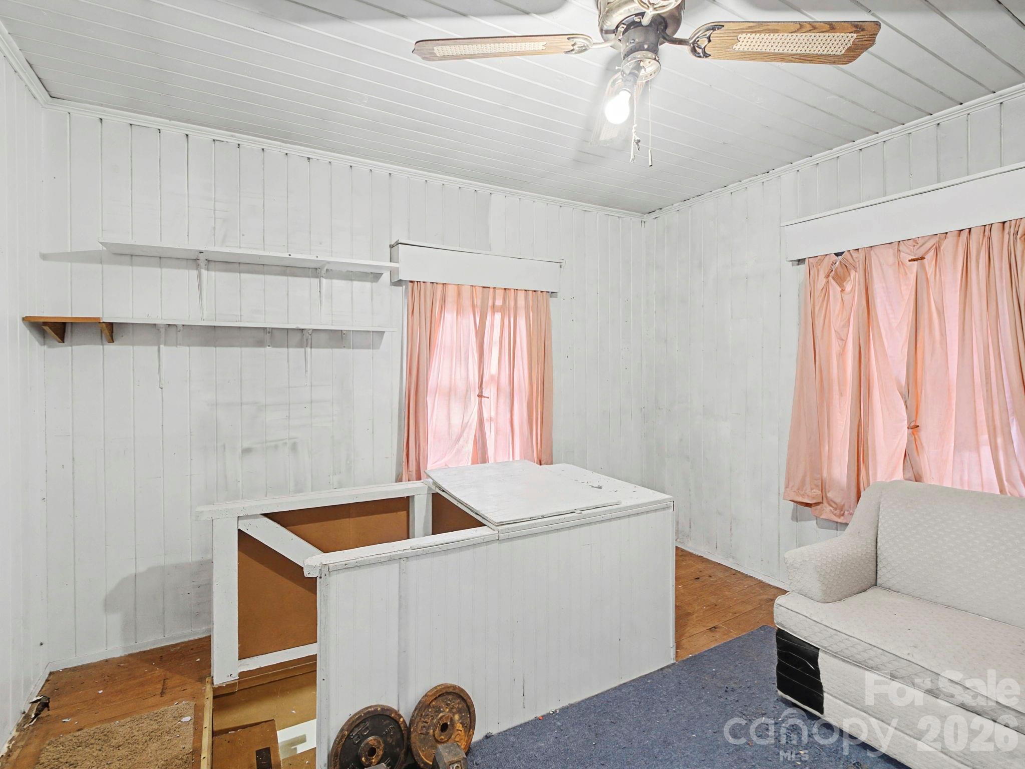 1526 Bills Creek Road Lake Lure, NC 28746 - Photo 22 of 25 a room with a couch and a large window