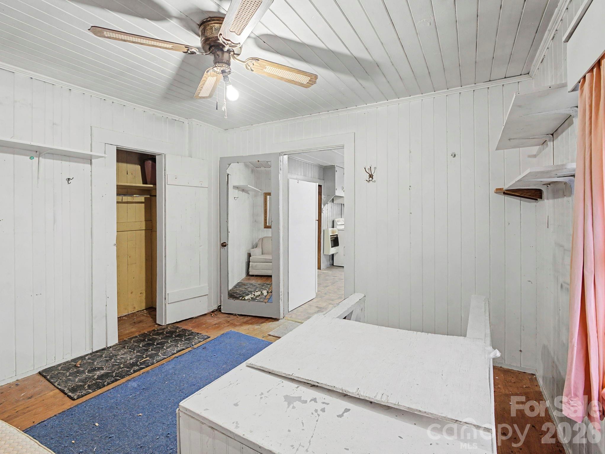 1526 Bills Creek Road Lake Lure, NC 28746 - Photo 23 of 25 a bedroom with a bed and a chandelier