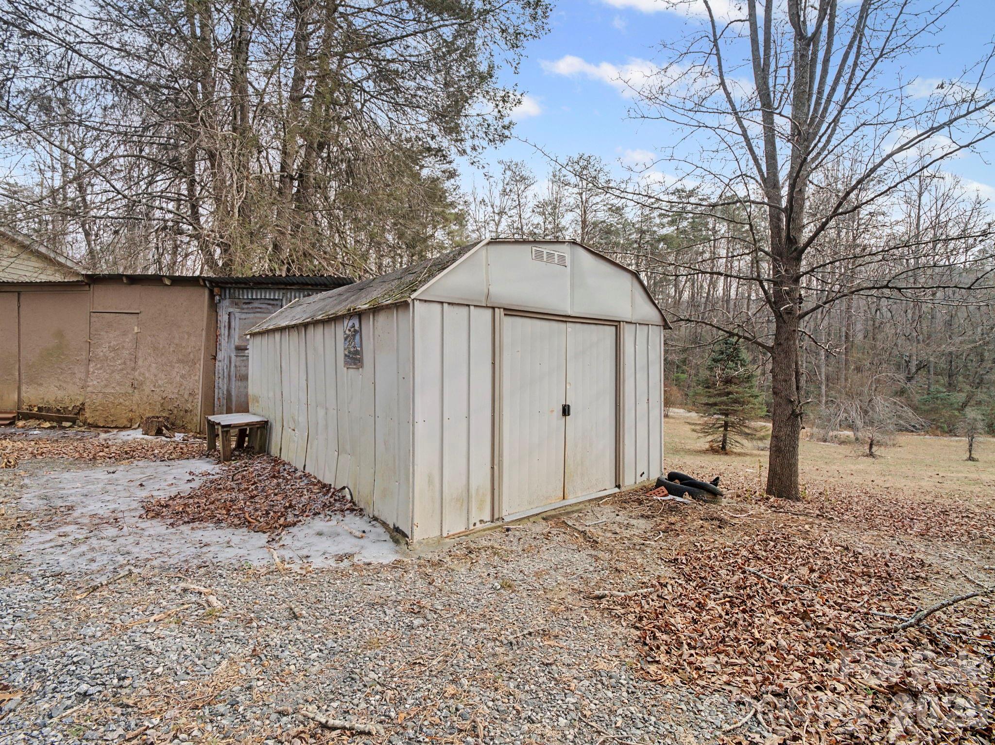 1526 Bills Creek Road Lake Lure, NC 28746 - Photo 5 of 25 a backyard of a house with a large tree