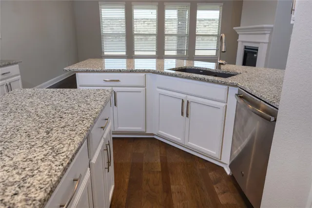 a kitchen with granite countertop a stove and a microwave