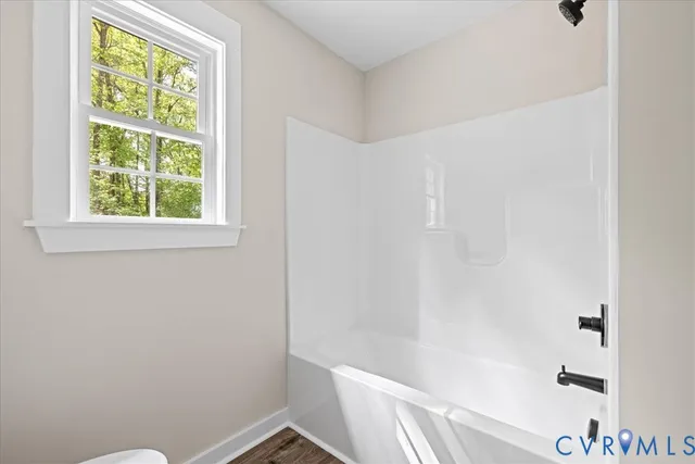 a bathroom with a window and a shower