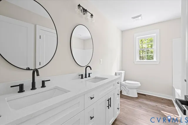 a bathroom with a toilet a sink and a mirror