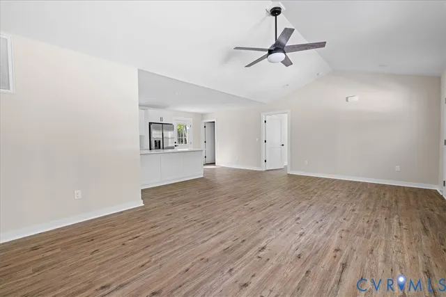 a view of room with hardwood floor and ceiling fan