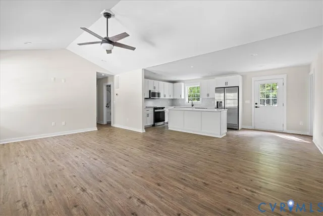 a view of a kitchen with a sink and a stove top oven