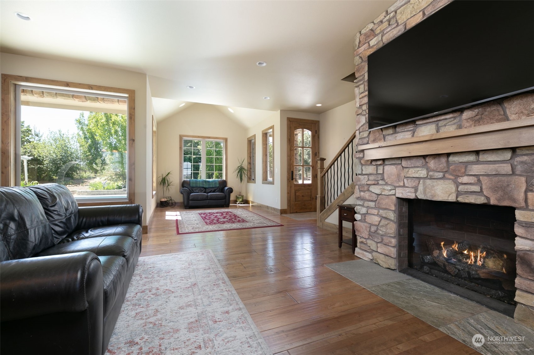 12302 Marble Road Yakima, WA 98908 - Photo 17 of 40 a living room with furniture a flat screen tv and a fireplace