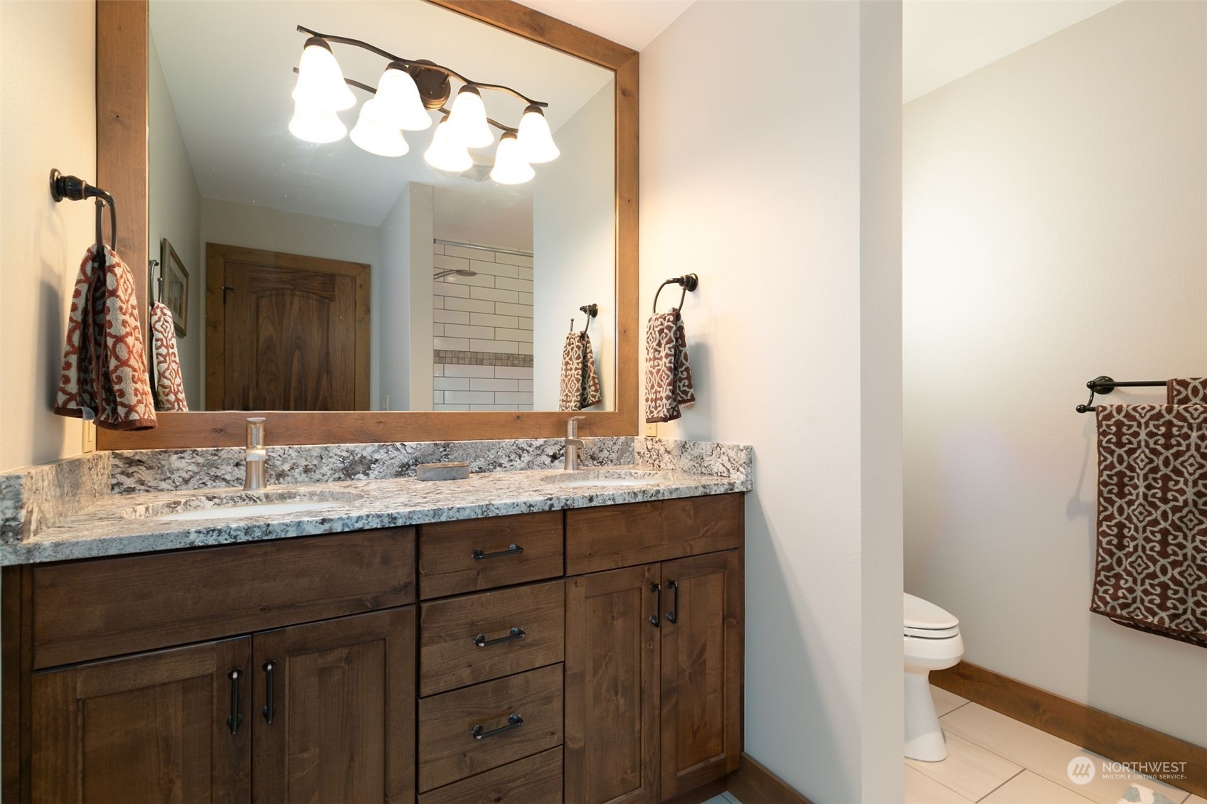 12302 Marble Road Yakima, WA 98908 - Photo 29 of 40 a bathroom with a granite countertop sink a toilet and a mirror