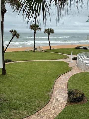 a swimming pool with lots of tress in the background